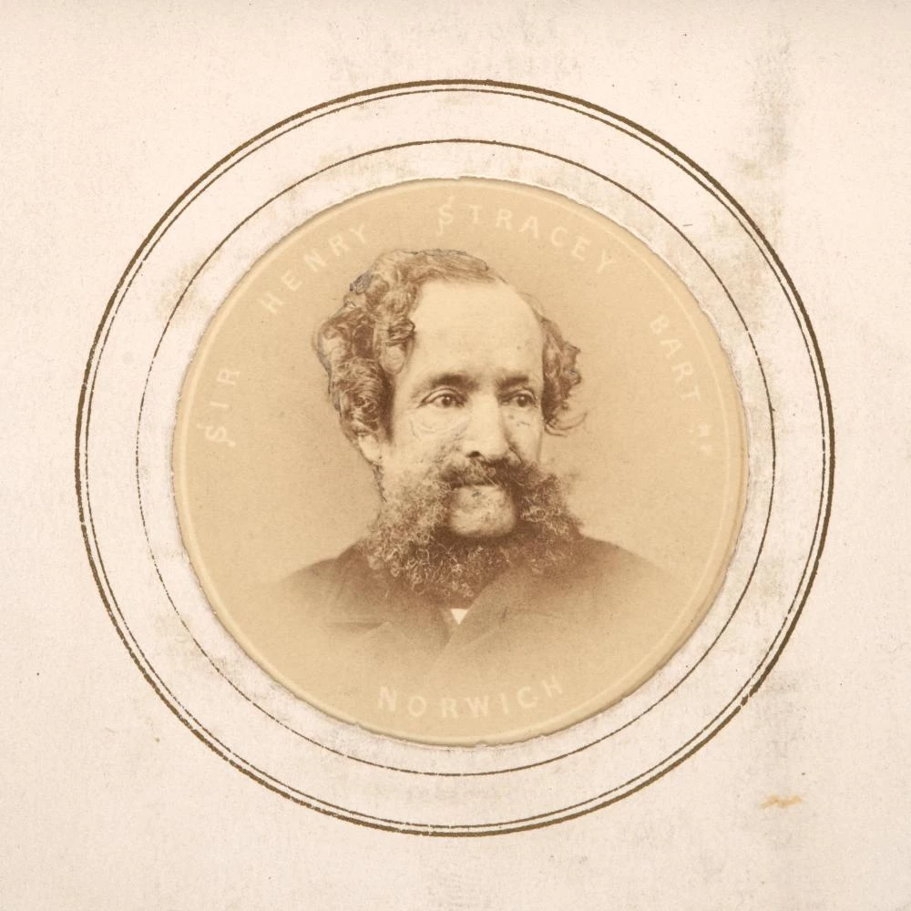 A sepia photograph of a middle aged man with high forehead and impressive beard.